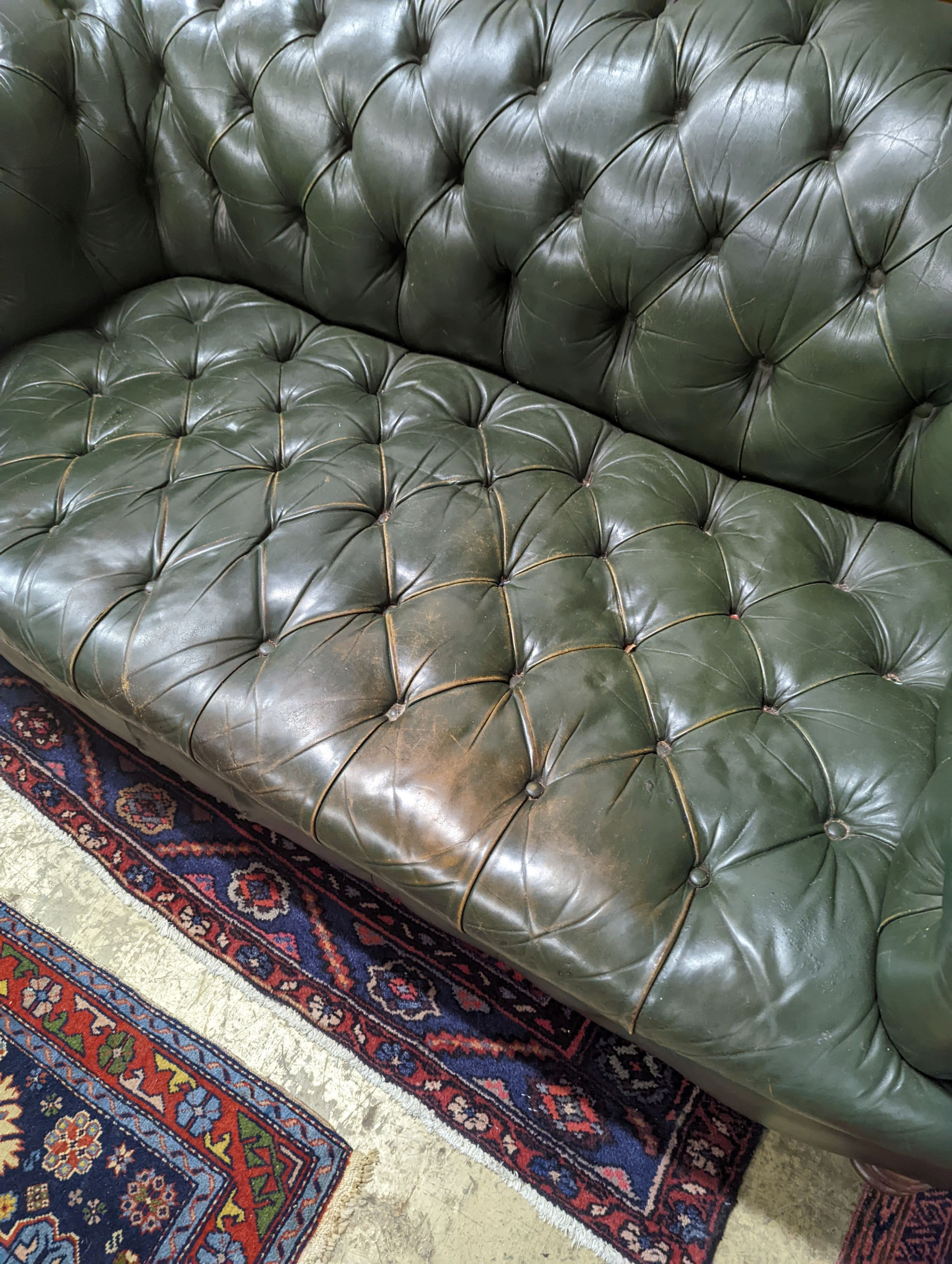 A late Victorian buttoned green leather Chesterfield settee, length 184cm, depth 82cm, height 70cm